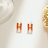 Wholesale Women's Silverplated Copper Oildrip Letter Earrings With Electroplating Process