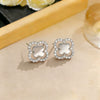 Wholesale Women's Sophisticated Diamond Leaf Pattern Copper Inlaid Zircon Four Leaf Clover Hollow Earrings
