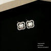 Wholesale Women's Sophisticated Diamond Leaf Pattern Copper Inlaid Zircon Four Leaf Clover Hollow Earrings