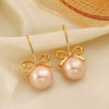 Wholesale Women's Stainless Steel And Pearl Bow Earrings With Electroplating Treatment