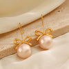Wholesale Women's Stainless Steel And Pearl Bow Earrings With Electroplating Treatment