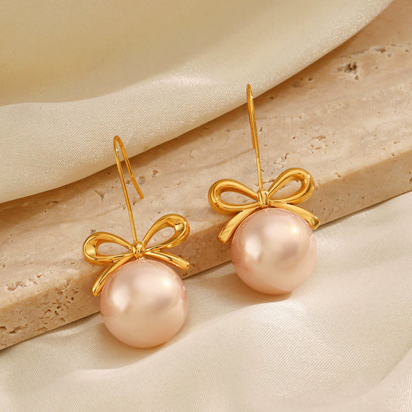 Wholesale Women's Stainless Steel And Pearl Bow Earrings With Electroplating Treatment