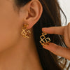 Wholesale Women's Stainless Steel Hollow Fourleaf Clover And Flower Earrings With 18K Gold Vacuum Plating
