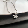 Wholesale Women's Titanium Steel Geometric Gold Inlaid Fourleaf Clover Ear Buckle Earrings Light Luxury Style