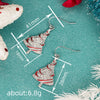Women's Copper Christmas Tree Earrings With Red Shimmering Oil Drip Effect Star Shape And Ribbon Wrapped Holiday Design