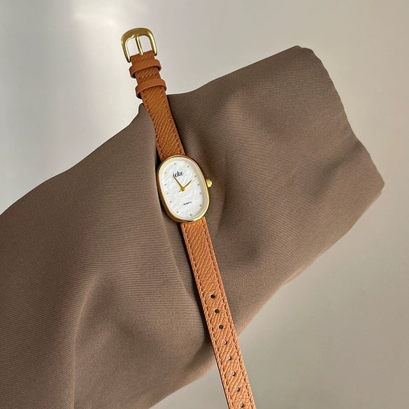 Women's Metal Case Genuine Leather Strap Oval Quartz Watch With Simple Temperament And Light Luxury Design