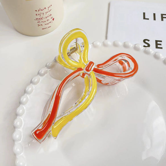 Women's Plastic And Resin Bow Grip Hair Clip With Dripping Oil Design