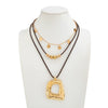 Women's Plated Alloy Geometric Hollow Square Pendant Necklace With Retro Brown Waxed Rope And Beaded Layered Design