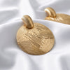 Women's Retro Geometric Round Metal Stud Earrings With Textured Embossed Gold Plating And Bold Statement Design
